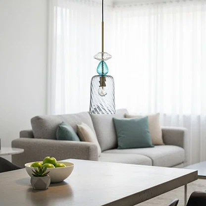 Blue glass pendant light above sofa adding modern elegance and warm ambient lighting to contemporary living spaces.