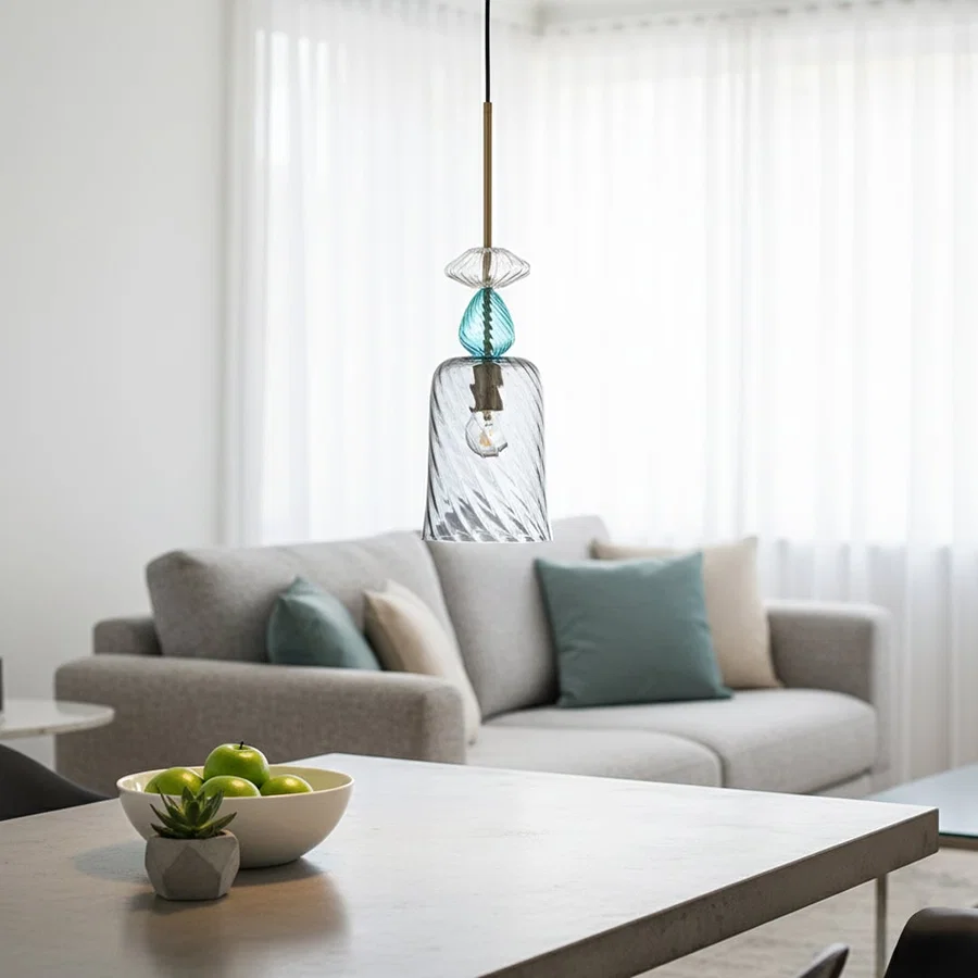 Blue glass pendant light above sofa adding modern elegance and warm ambient lighting to contemporary living spaces.