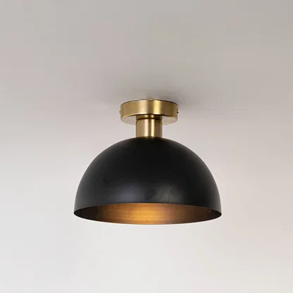 Modern black metal dome ceiling light with warm glow for contemporary bedroom and minimalist decor styling spaces.