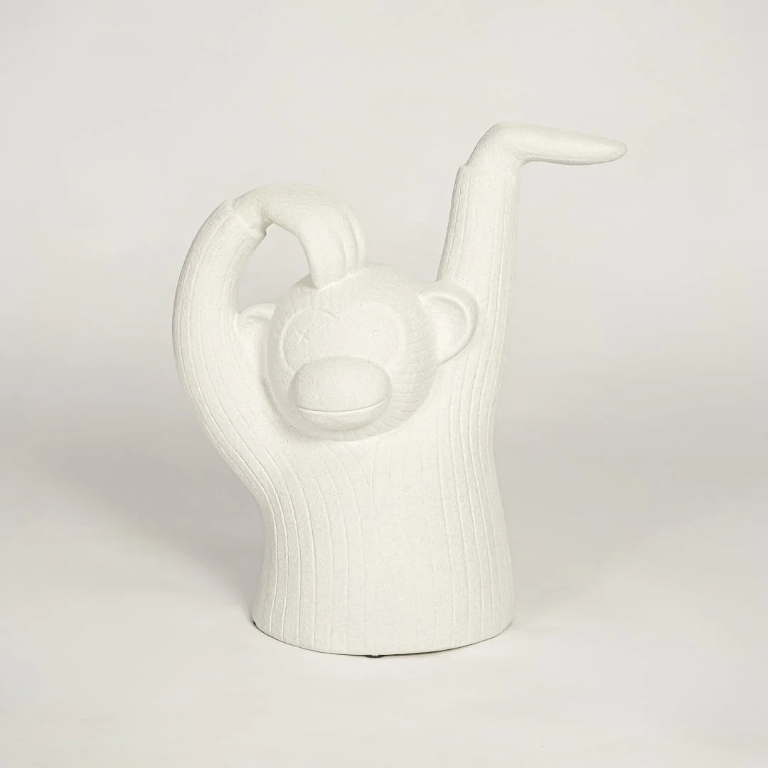 Modern white monkey figurine decor on white background textured sculptural accent for shelf console or office styling.
