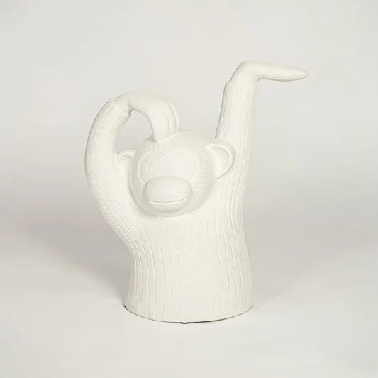 Modern white monkey figurine decor on white background textured sculptural accent for shelf console or office styling.