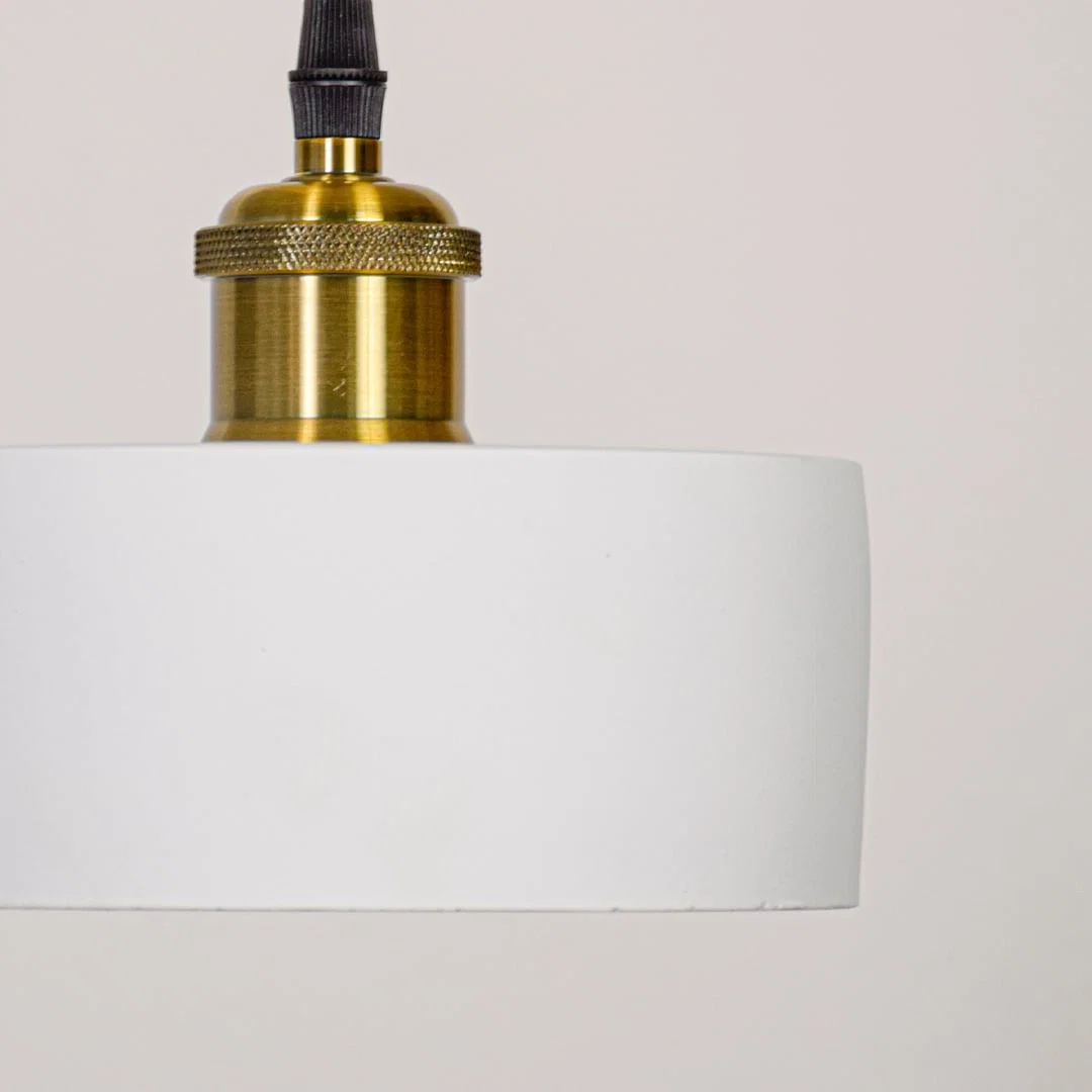 Detailed view of white metal pendant light highlighting smooth finish and premium gold accents.