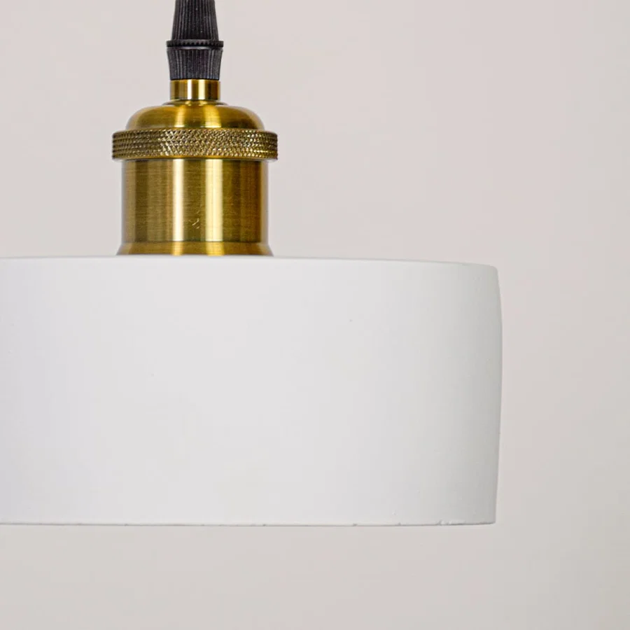 Detailed view of white metal pendant light highlighting smooth finish and premium gold accents.