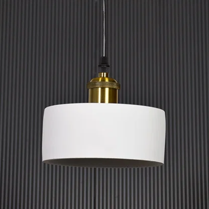 White metal pendant light with gold holder switched off on black background highlighting simple form and premium finish.
