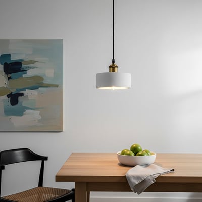 White metal pendant light above dining table adding minimalist elegance and soft ambient charm.