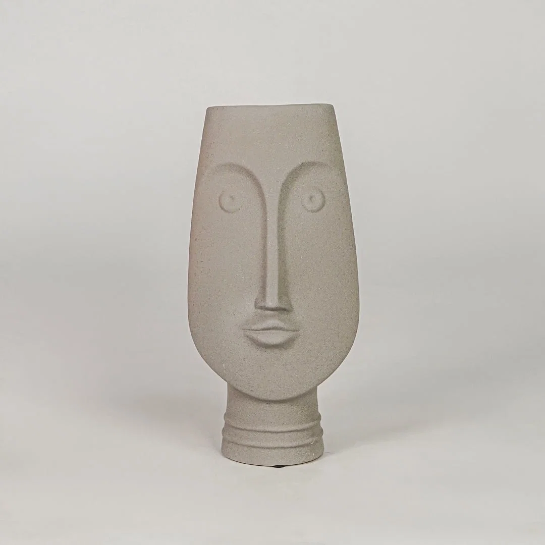 Beige face ceramic vase for modern shelf placement and elegant indoor home decor styling accent piece.