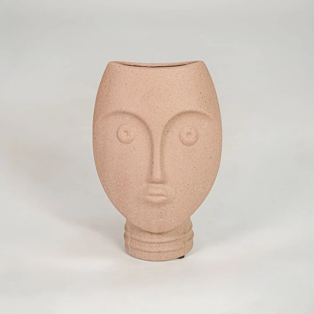 Pink textured face ceramic vase for stylish console table placement and contemporary indoor decor styling.