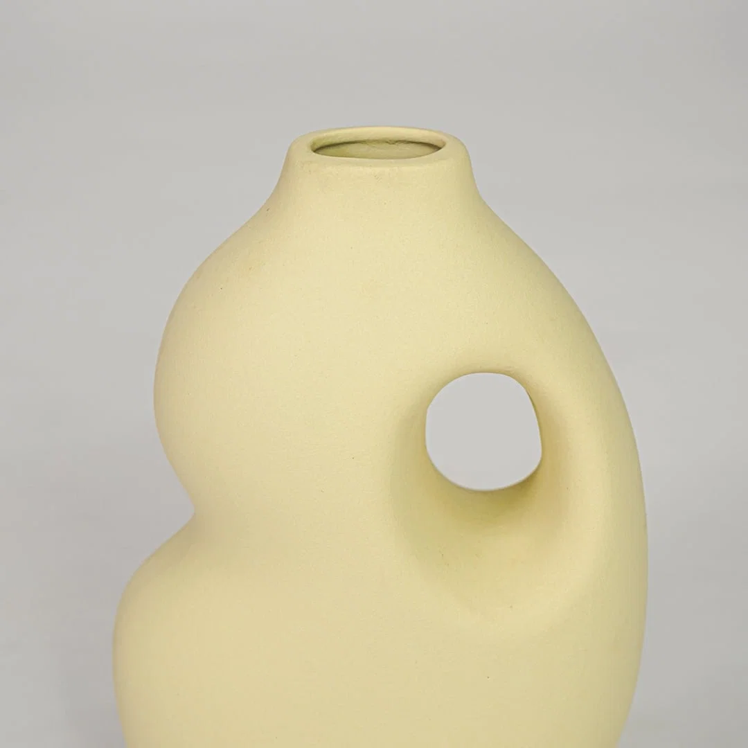 Yellow ceramic decorative vase closeup modern flower vase for shelf console table living room home decor styling.