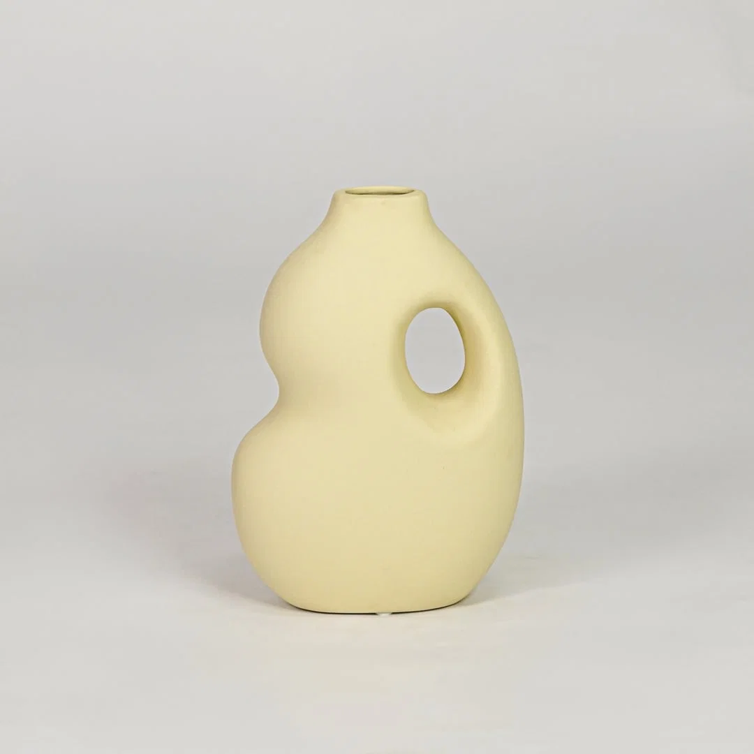 Yellow ceramic decorative vase with modern design flower vase for tabletop shelf console living room decor styling.