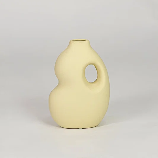 Yellow ceramic decorative vase with modern design flower vase for tabletop shelf console living room decor styling.