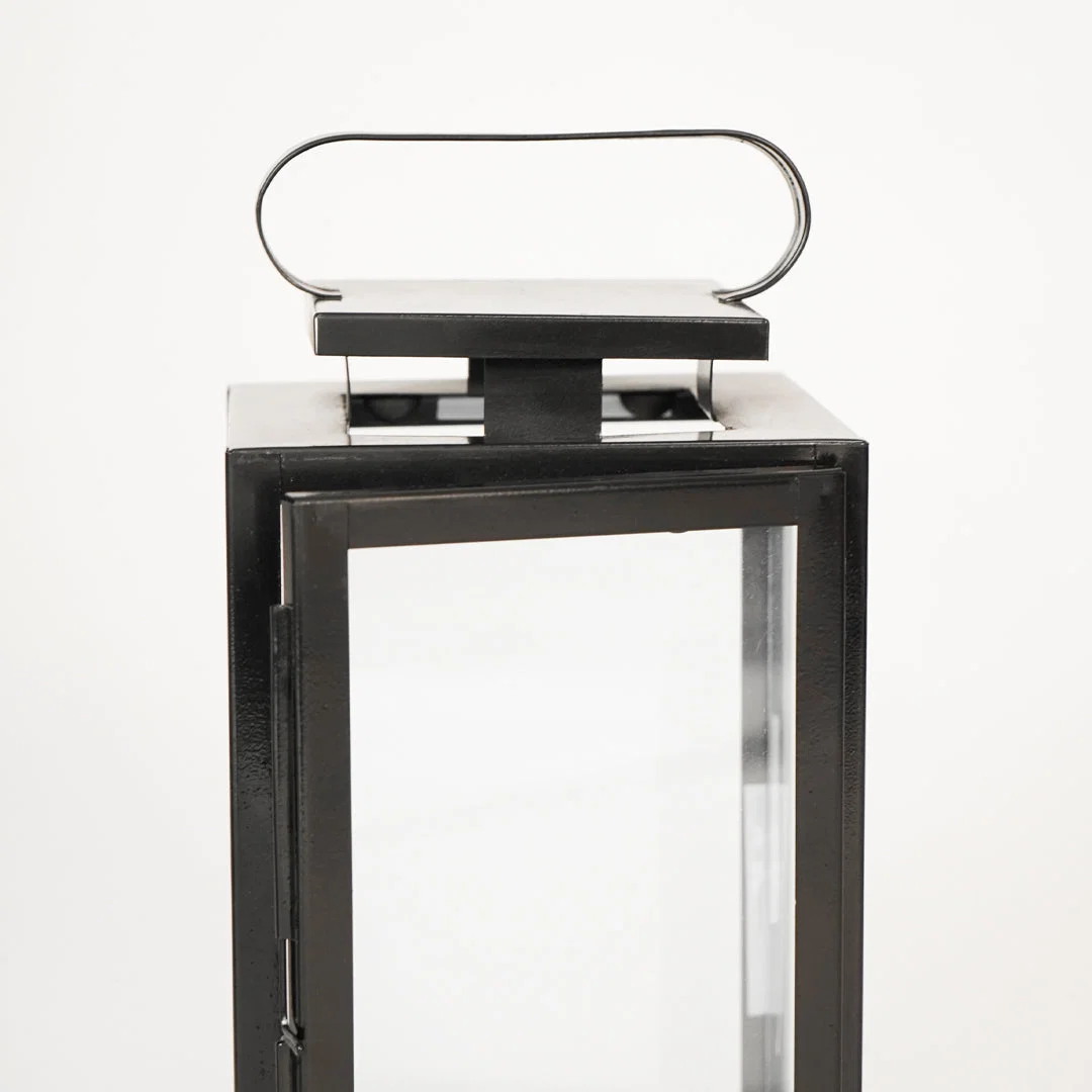 Closeup image of medium metal tower lantern for modern tabletop decor styling with durable sleek metallic finish detailing.