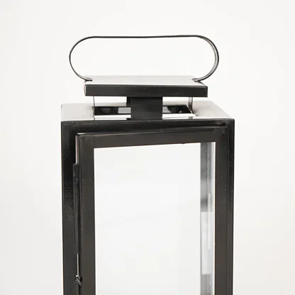 Closeup image of medium metal tower lantern for modern tabletop decor styling with durable sleek metallic finish detailing.