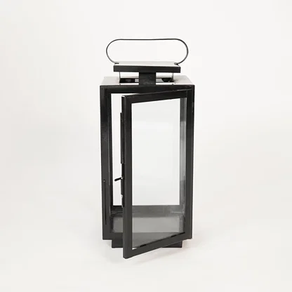 White background image of medium metal tower lantern for modern indoor decor styling with clear glass side panels display.