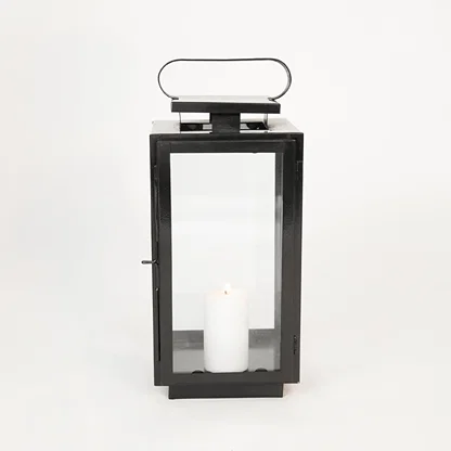 White background image of medium metal tower lantern for elegant table decor styling with sleek metallic finish.