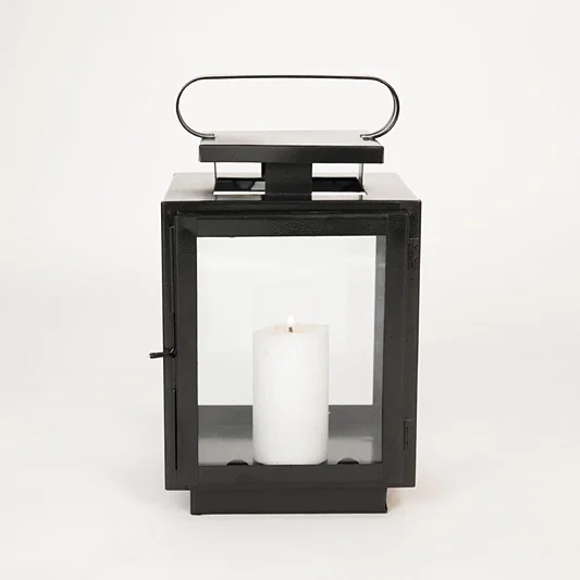 White background image of small metal tower lantern for elegant table decor styling with sleek metallic finish.