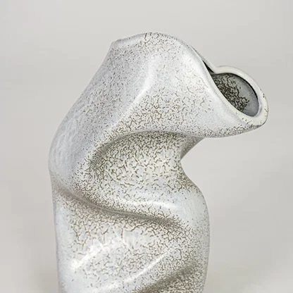 Closeup grey ceramic textured abstract designer vase surface detail modern decorative flower vase for table shelf home decor styling.