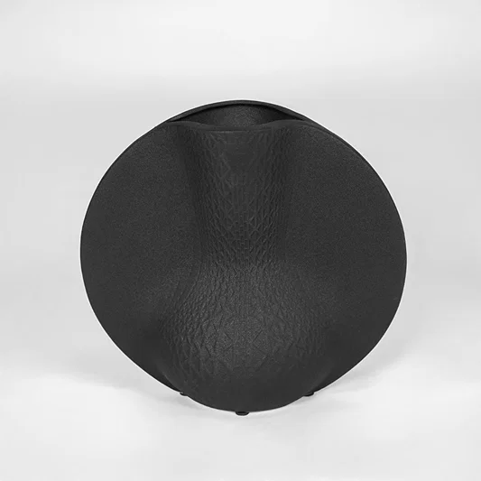 Black textured decorative plate for modern wall placement and contemporary indoor home decor styling accent piece.