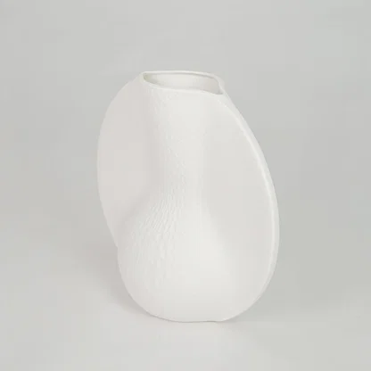 White background image of white ceramic abstract vase for modern tabletop decor styling with matte finish.