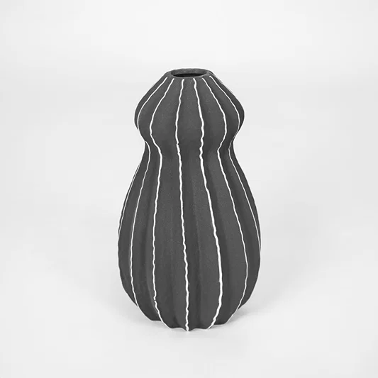 Black textured ceramic vase with striped design for modern shelf placement and elegant indoor decor styling accent.