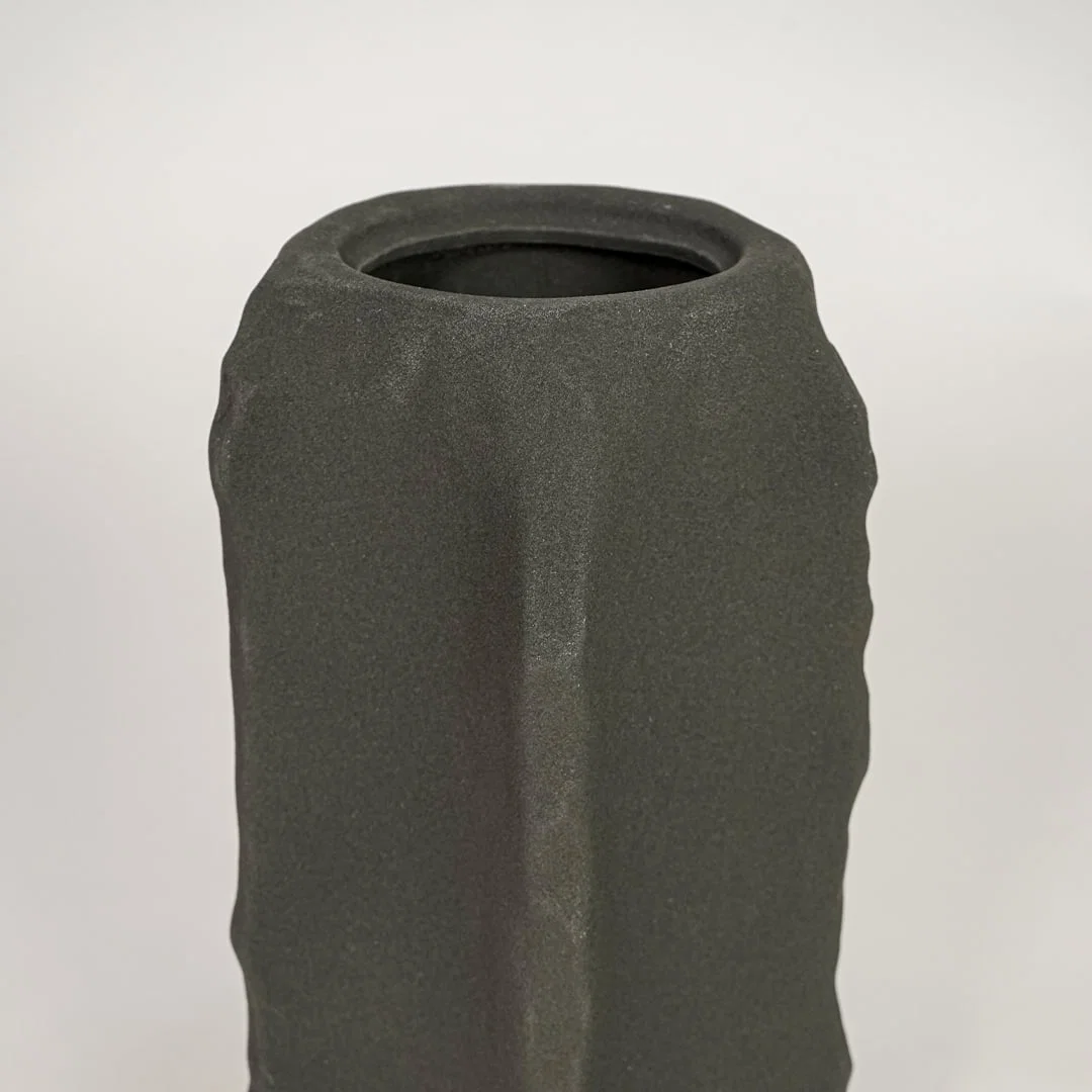 Closeup of dark grey ceramic vase with textured matte finish for elegant tabletop and shelf decor styling ideas.