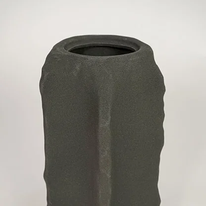 Closeup of dark grey ceramic vase with textured matte finish for elegant tabletop and shelf decor styling ideas.
