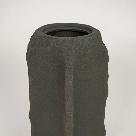 Closeup of dark grey ceramic vase with textured matte finish for elegant tabletop and shelf decor styling ideas.
