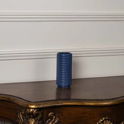 Blue textured ceramic vase displayed on a clean white background ideal for sleek home decor and elegant tabletop styling.