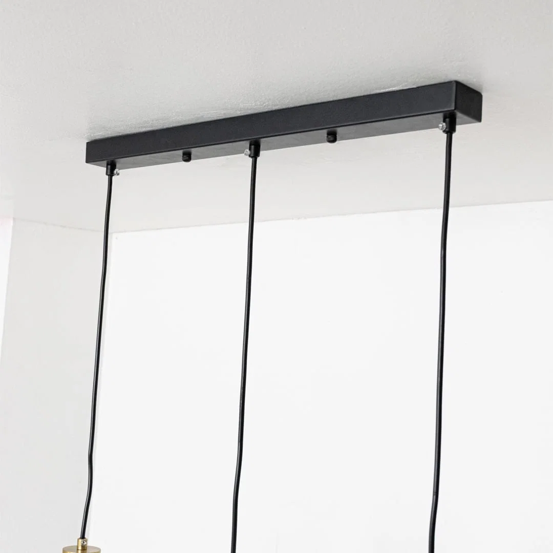 Black metal linear ceiling canopy with hanging cords highlighting premium finish and craftsmanship.