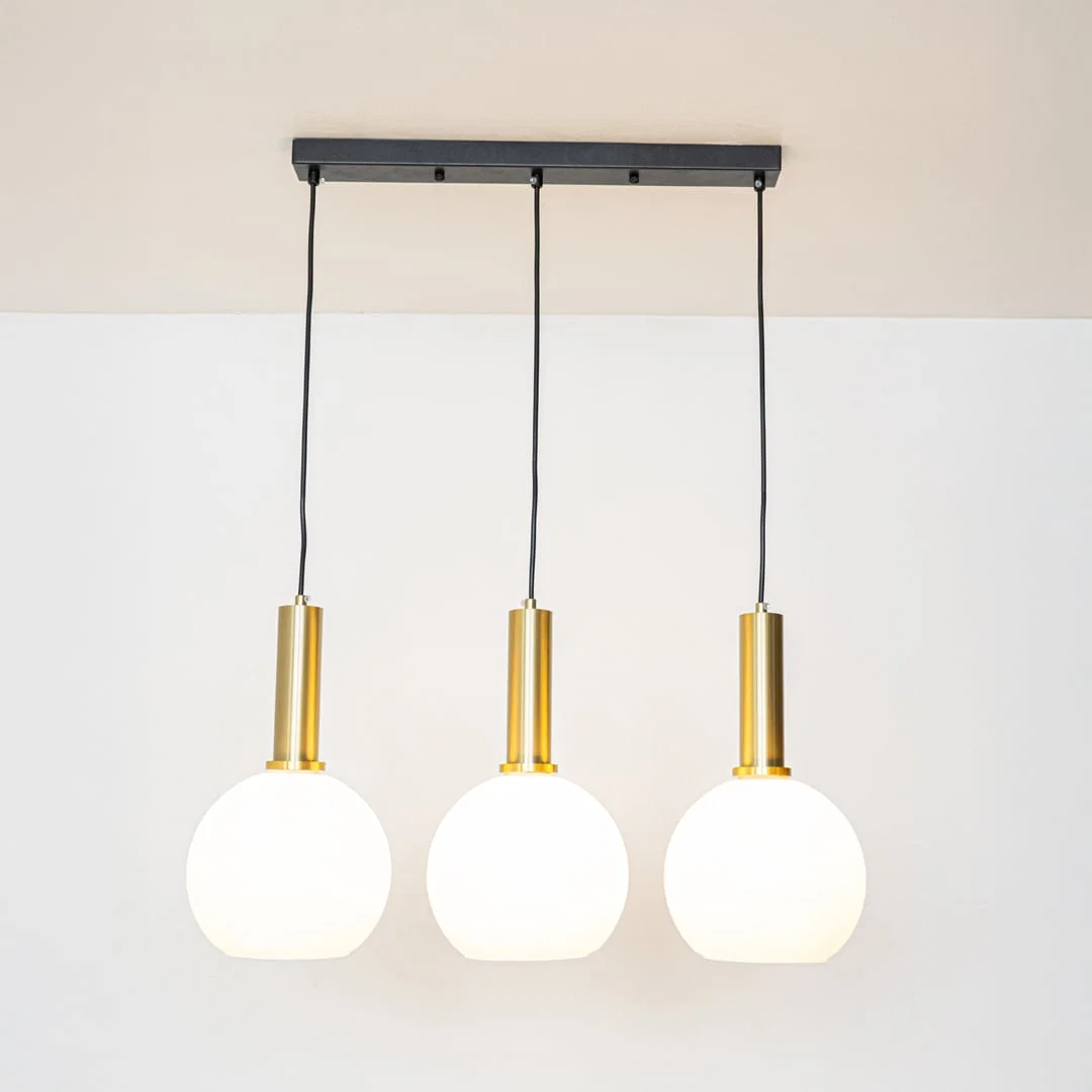 White glass and gold metal pendant lights showcasing stylish designs for contemporary home decor.