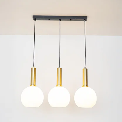 White glass and gold metal pendant lights showcasing stylish designs for contemporary home decor.