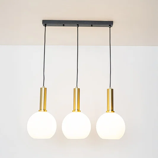 White glass and gold metal pendant lights showcasing stylish designs for contemporary home decor.
