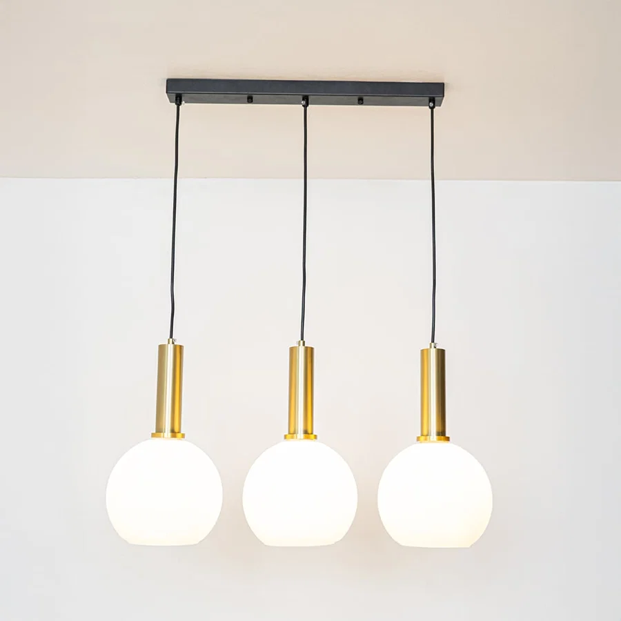 White glass and gold metal pendant lights showcasing stylish designs for contemporary home decor.
