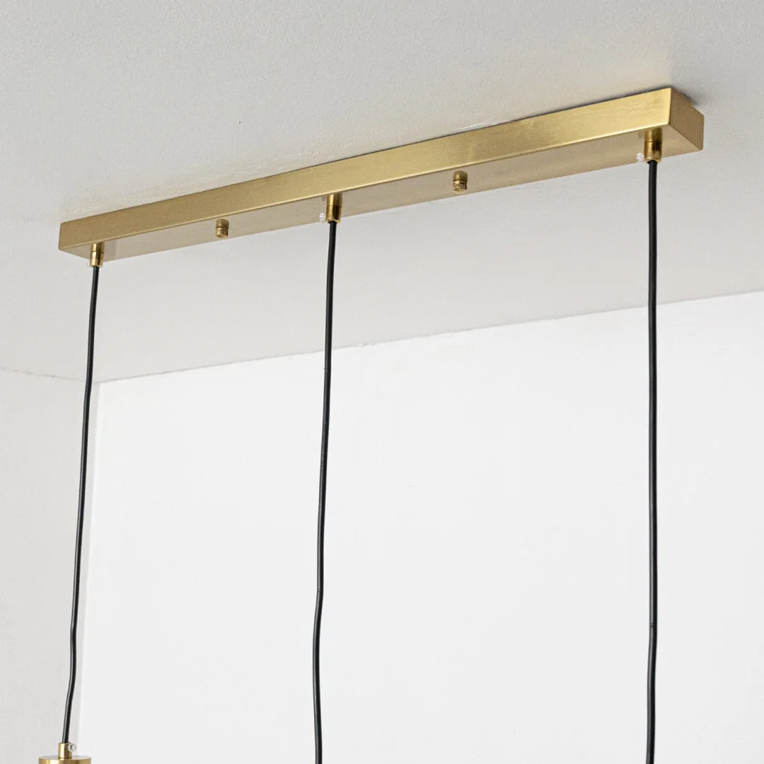 Gold metal ceiling bar with hanging cords showcasing minimalist design and premium craftsmanship.