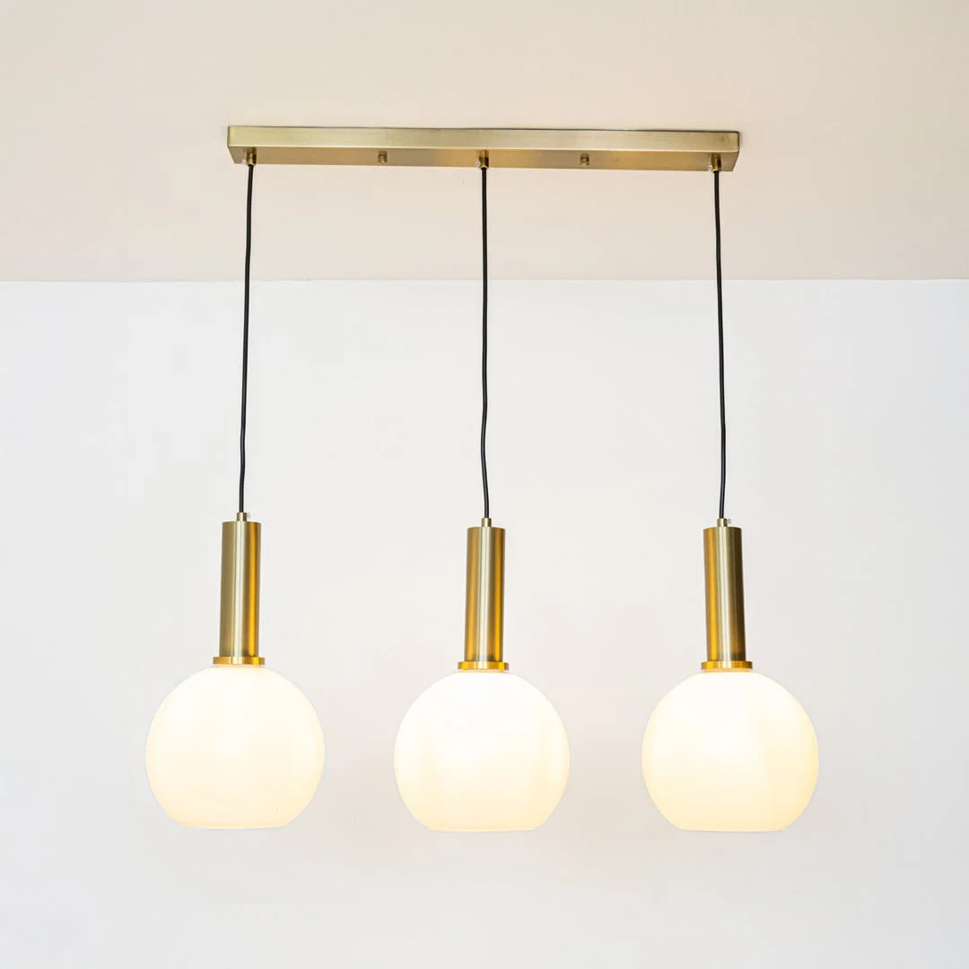 White glass and gold metal pendant lights showcasing stylish designs for contemporary home decor.