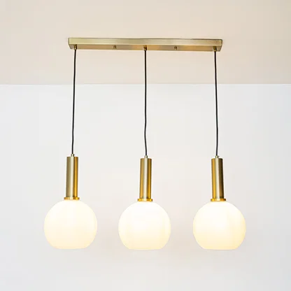 White glass and gold metal pendant lights showcasing stylish designs for contemporary home decor.