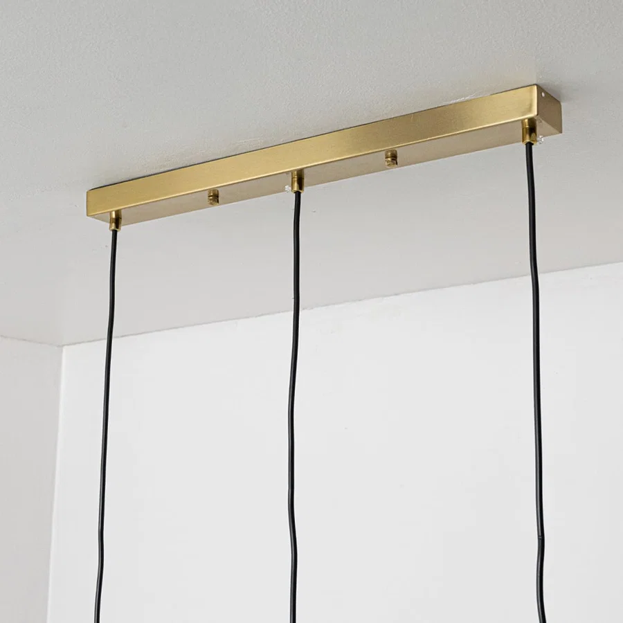 Gold metal linear ceiling canopy with suspended cords showcasing sleek modern craftsmanship and finish.
