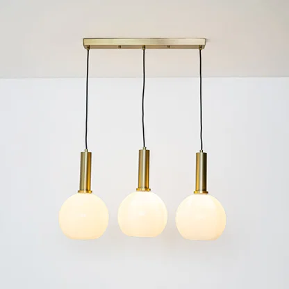 White glass and gold metal pendant lights designed for sophisticated contemporary home decor spaces.
