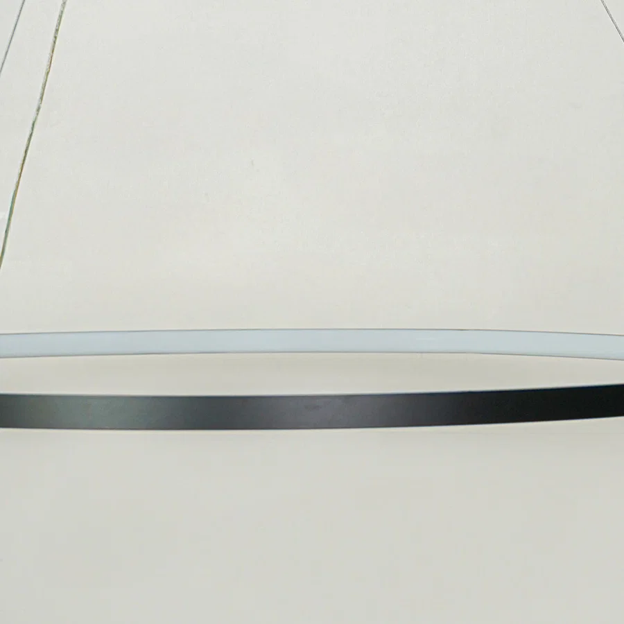 Contemporary sleek linear hanging light with black finish displayed against soft white ceiling background perfect for modern interior decor lighting.