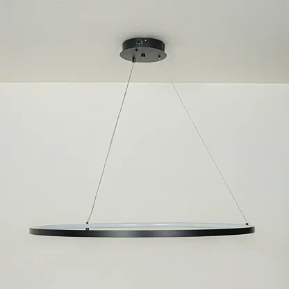 Modern slim black linear pendant light suspended by cables against clean white ceiling background ideal for minimalist kitchen or dining lighting.