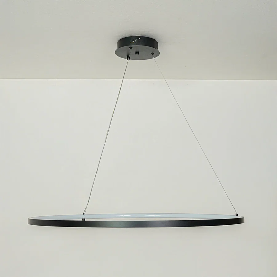 Modern slim black linear pendant light suspended by cables against clean white ceiling background ideal for minimalist kitchen or dining lighting.