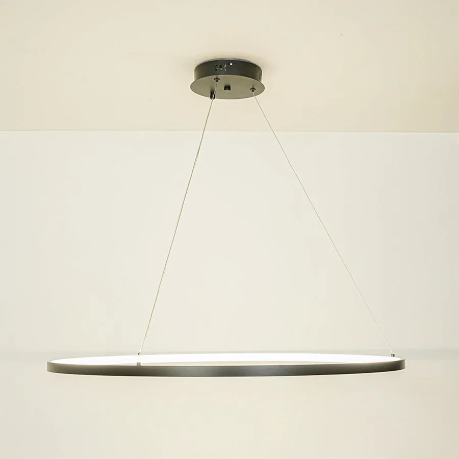 Minimal black linear pendant light with sleek design suspended by thin cables against white ceiling background perfect for modern interiors.