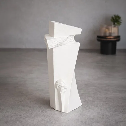Tall white ceramic floor vase with sculpted texture styled in living room corner for modern decor accent.
