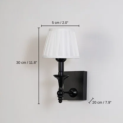 Black metal wall sconce with white pleated shade, base 30 x 5 x 20 cm (11.8 x 2.0 x 7.9 inches), canopy 12 x 10 cm (4.7 x 3.9 inches) dimensions