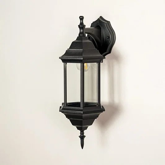Black metal outdoor wall lantern with clear glass panels for modern exterior lighting decor placement styling.