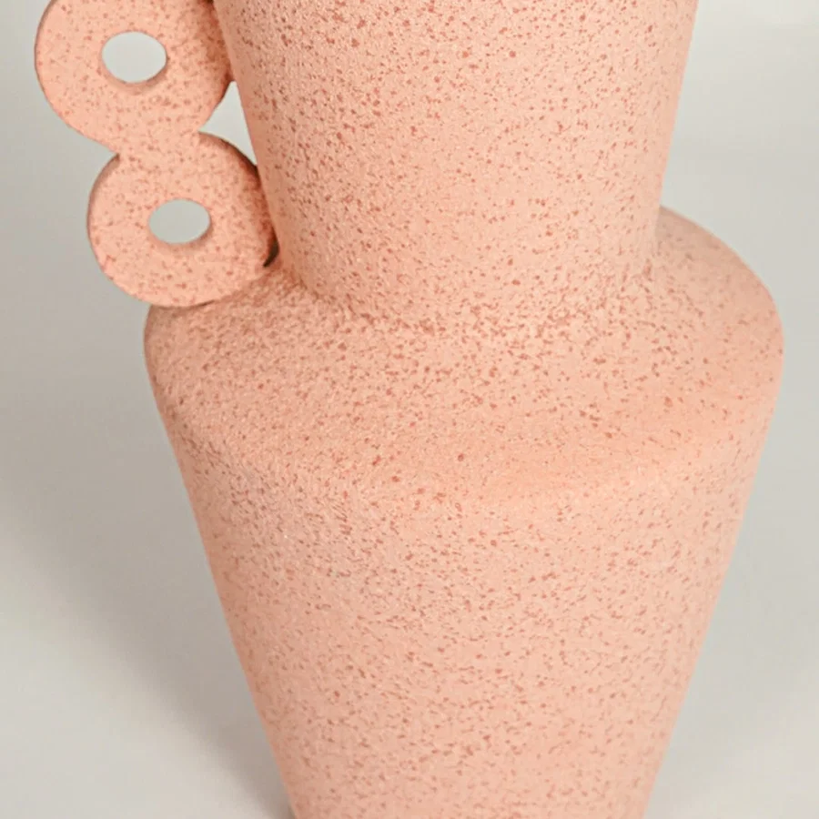 Close up view peach decorative ceramic vase showing unique side handle design textured finish accent for shelf styling home.
