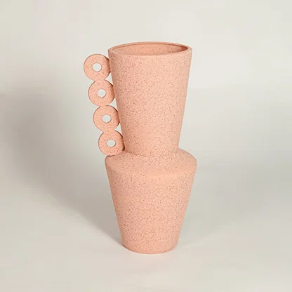 Peach decorative textured ceramic vase on white background modern home decor accent piece for table floor console styling.