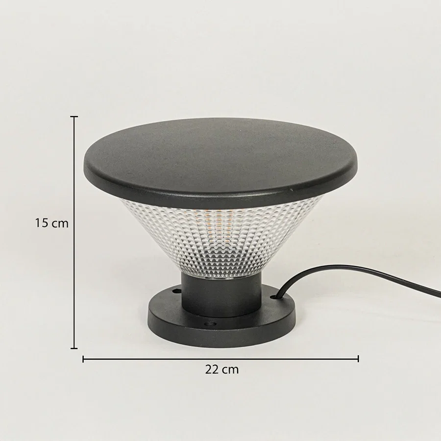 Contemporary outdoor surface light with black metal top and textured glass diffuser on neutral background 15 cm height 22 cm width ideal for garden or pathway lighting.

