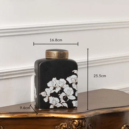 Black square jar with white floral artwork in a front view measuring 15.5 cm width and 20.8 cm height perfect for luxury décor styling.