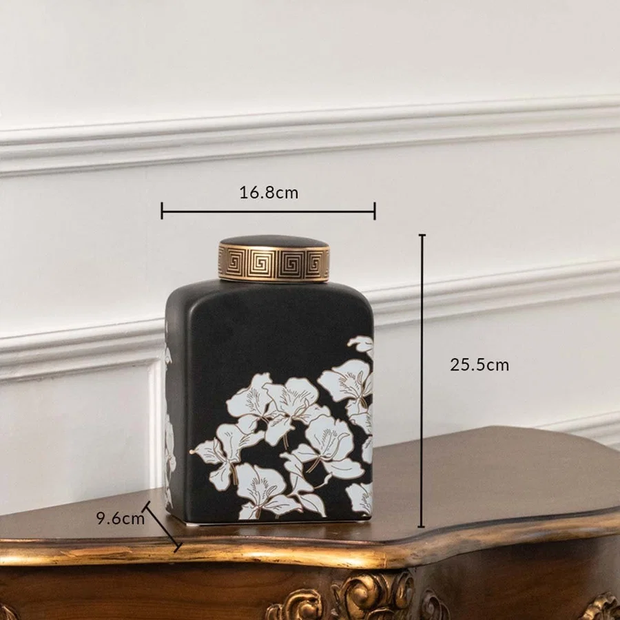 Black square jar with white floral artwork in a front view measuring 15.5 cm width and 20.8 cm height perfect for luxury décor styling.