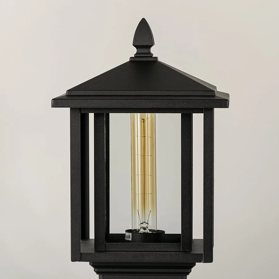 Black outdoor lantern Closeup Light On showing warm glow and decorative pebbled glass panels for exterior lighting.